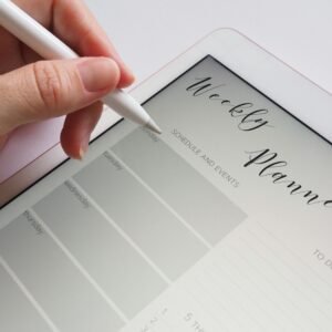 A stylus writing in a digital weekly planner on a tablet screen, ideal for organization.